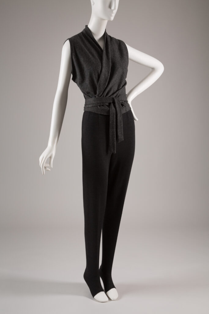 a grey knit wrap top with black leggings on a mannequin